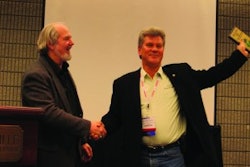 Ray Confer (right), president of C&J Parking Lot Sweeping, Warren, MI, accepts the 2011 WorldSweeper.com Award of Excellence in Power Sweeping from Ranger Kidwell-Ross, editor of WorldSweeper.com.