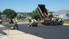 Another crew member followed the paver and the roller with a walk-behind compaction plate to ensure all edges along the sidewalk and parking lot were compacted properly.