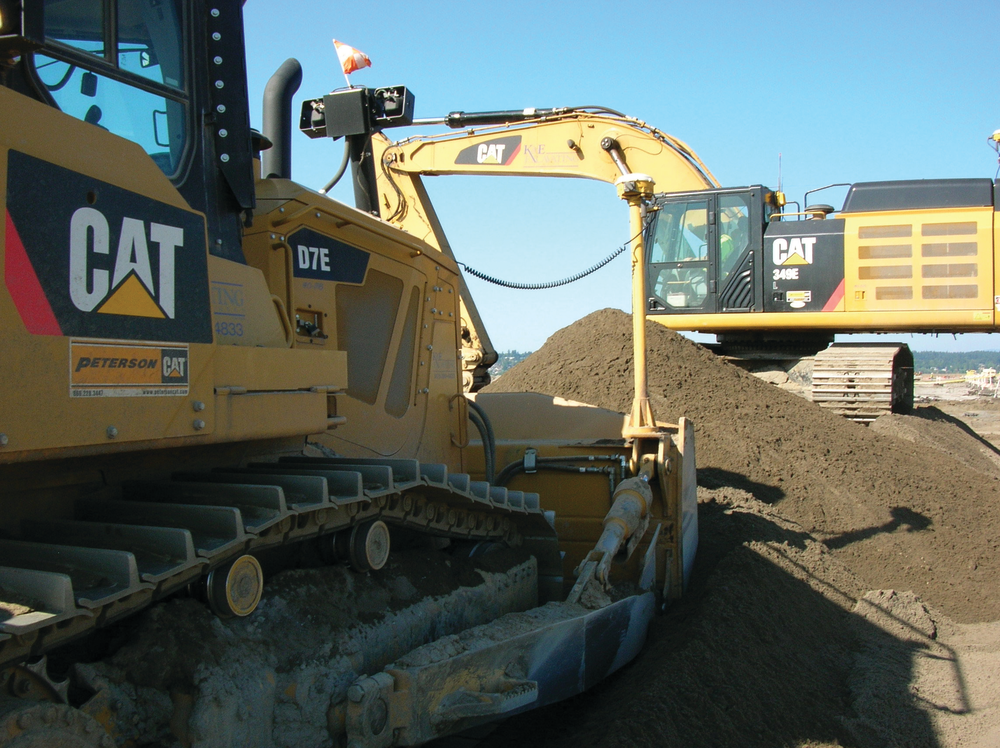 K&E Excavating&rsquo;s D7E uses half the fuel of the company&rsquo;s previous model. The company owns 115 pieces of Cat equipment, including the D7E and a 349E (shown working in the background).