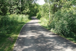 E&B was contracted to build a trail that ran .7 miles through an area that was completely covered in brush and trees, which wound along the river and under the Carroll Bridge.
