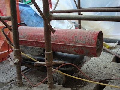 When using combustion heaters for heating enclosures, ensure proper exhaust ventilation to prevent carbonization of concrete and carbon monoxide safety issues for workers.