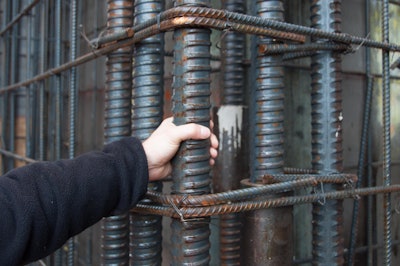 The decision to use #20 grade 97 rebar for vertical reinforcement reduced congestion and was cost productive. With the deformations in a threaded pattern, couplers could be used to join bars together and transfer load.