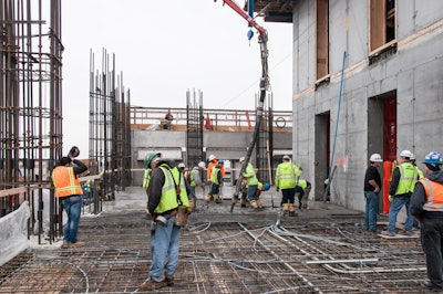 With the core structure on the right and the exterior columns and spandrels on the left of the photo, the 10' thick 'flat plate' floors act as a diaphragm, joining the two vertical elements together.