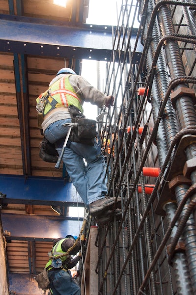The exterior forms for the core roll outward 5 feet on the blue I-beams at the top of the picture, allowing the ironworkers room to place reinforcement.