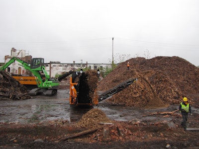 The Sennebogen 821 material handler feeds a pair of grinders as part of Costello Dismantling's efforts to maximize the revenues from demolition projects.
