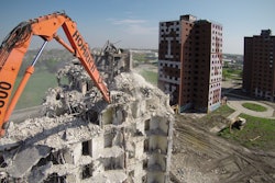 Contractor Homrich utilized its Hitachi 800 Ultra High Reach, in combination with an old-fashioned wrecking ball hung from a 200-ton truck crane to safely demolish four 15-story high-rise buildings.