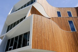 The building features distinct curves and apertures that make it standout visually as well as allow sunlight and shade to be optimized for the lighting and temperature, saving energy and enhancing comfort levels for occupants.