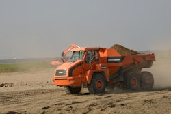 The articulated dump trucks make dozens of trips each day hauling sand. By the time the project is completed, they will have delivered more than 160,000 cu. yds. of it to the breakwaters.