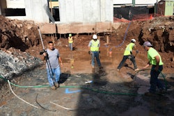 Workers can accurately locate points regardless of site conditions such as in excavations, sloped areas, or in mud. The instrument can be located at a safe distance from construction traffic and automatically compensate. The worker shown here is carrying the rod with a computer tablet mounted on it.