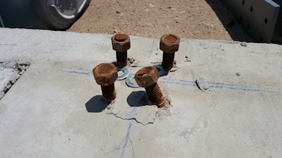 Photo 3 - For misaligned or bent anchor bolts that will not allow the base plate to fit over the bolts, consider bending the bolts into position.