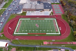 Approximately 1,800 tons of E mix asphalt was placed in two layers. ACI laid the base course, placed tack and then placed the surface course of the running track.