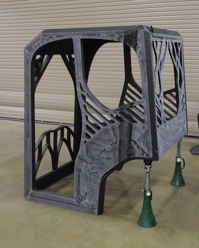 The completed 3D printed excavator cab was printed with an additive manufacturing machine that used carbon fiber-reinforced acrylonitrile butadiene styrene (ABS) plastic.