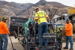 In South Ogden, UT, Aspen Paving Inc. places asphalt in 6-ft.-wide secondary water line cut.