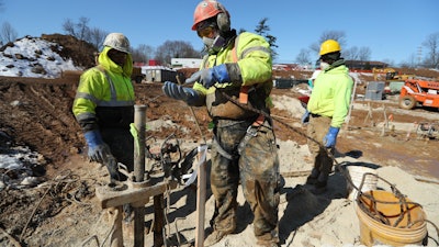 The 2-in. inside diameter temporary casing was equipped with a bullet point on the bottom that was intentionally knocked out by yanking a rope from ground level to avoid clogging the pipe with grout.