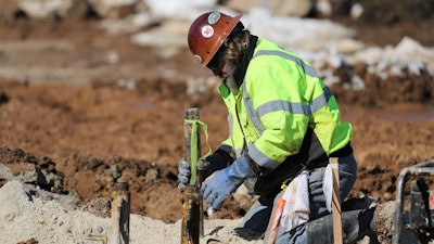 Mike Miluski, CGS VICE PRESIDENT, checks the temporary casing to prepare for grout injection.
