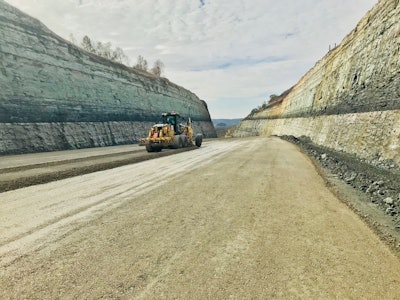 For the project's 20 million cu. yds. of earthmoving, Beaver Excavating was averaging 1 million cubic yards of excavated material a month with six Hitachi machines running. The project's “earthmoving” consisted of 97 percent rock — sandstone, shale and limestone — that was blasted every day. Beaver Excavating also made cuts as deep as 200 ft. and used the material for fill on other parts of the project which included 3-ft. of shot rock placed for a roadbed layer prior to paving.