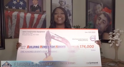 Natasha De Alencar, Gold Star Wife, holding donation check