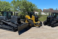 The first two commemorative units were D6 XE electric drive dozers, featuring a sleek dark gray and black paint scheme. The third commemorative unit is a D6 dozer finished in traditional Cat yellow with special black tracks and blade.
