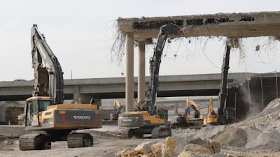 The EC480 HR ran a 10,000-lb. NPK-E225 hoe ram to break the vertical walls of the bridges, while the EC750E worked behind it used an Epiroc CC6000 Combi Cutter attachment to crunch the horizontal slabs and 1.5-in. rebar.