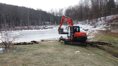 Marlboro Mount Construction used an 8-ton Kubota KX080 excavator paired with an Engcon Tiltrotator and a Werk-Brau Power Grip Bucket to build a trail through a dense stand of trees, along soft ground, around a lake.