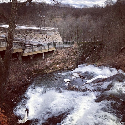 The Power Grip Bucket and Tiltrotator proved essential in building a 12-ft. retaining wall along a cliff overlooking Dead Man Falls in upstate New York.