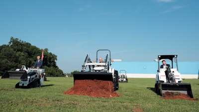 Doosan Bobcat executives break ground on the facility using Bobcat equipment.