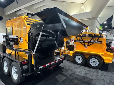 KM International's PWX booth, featuring their asphalt recycler and asphalt hotbox trailer.
