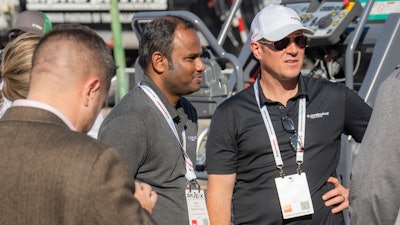 (Left) Vijay (Right) Jamie Roush, President and General Manager of Dynapac talking with attendees in the live demo area at PAVE/X 2024.