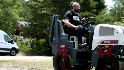 Brandon Noel, Editor, compacting gravel base for a driveway.