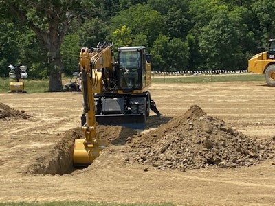 An excavator demonstrates the preciseness of grade control during a breakout session.