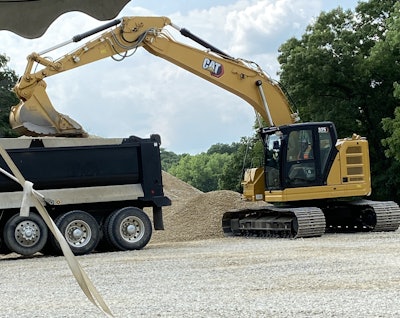 A 325 excavator demonstrates payload indication during the breakout sessions.