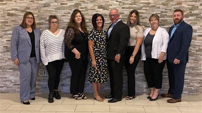 The staff of the Allied Trades Assistance Program. From left to right Naomi Margiotta (Claims Representative), Robyn Tutela-Zarli (Client Care Representative), Marianne Kochersperger (Claims/Client Care Representative), Marianne Wolfe (Managed Care Supervisor), Ken Serviss (Executive Director), Heather Russell (Senior Client Care Coordinator), Tina Rowan-Coll (Client Care Manager), and Joe Carey (ILA Pier Counselor).