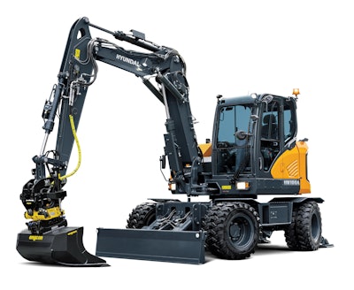 The Hyundai HW100A comes standard with a two-piece boom for enhanced reach and versatility, a front bucket rest, and a rear dozer blade. It is also equipped with quick coupler piping and selectable control pattern (ISO/SAE) for operator preference.