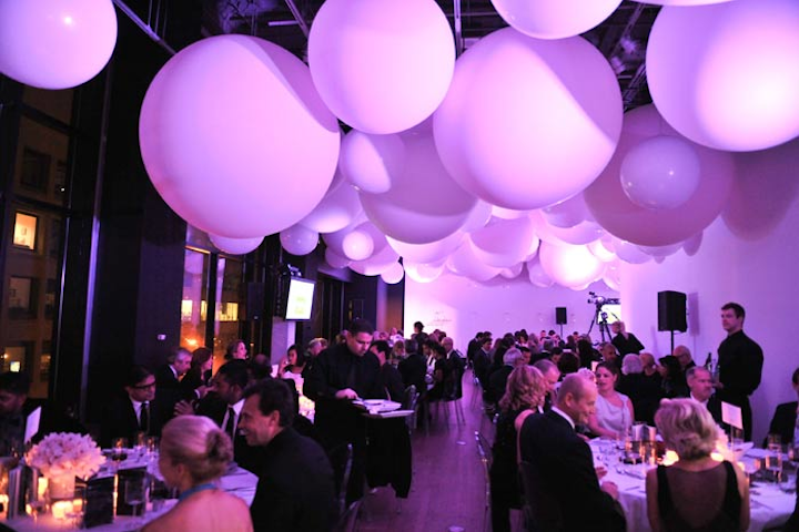 Hundreds of balloons from Balloon Trix hung from the ceiling during the V.I.P. dinner. The space changed colour with each course, starting with blue, morphing to pink for the main course, changing to orange for dessert, and ending in red.