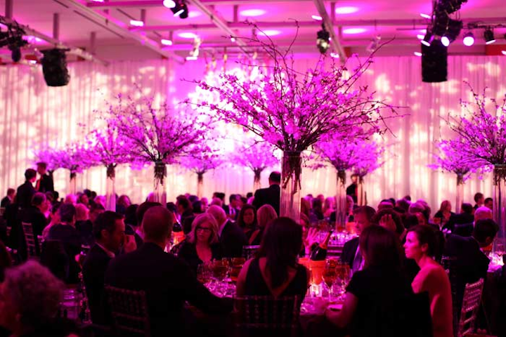 For dinner in Baillie Court, tall cherry blossoms added height to the tables. The space was uplit in pink.