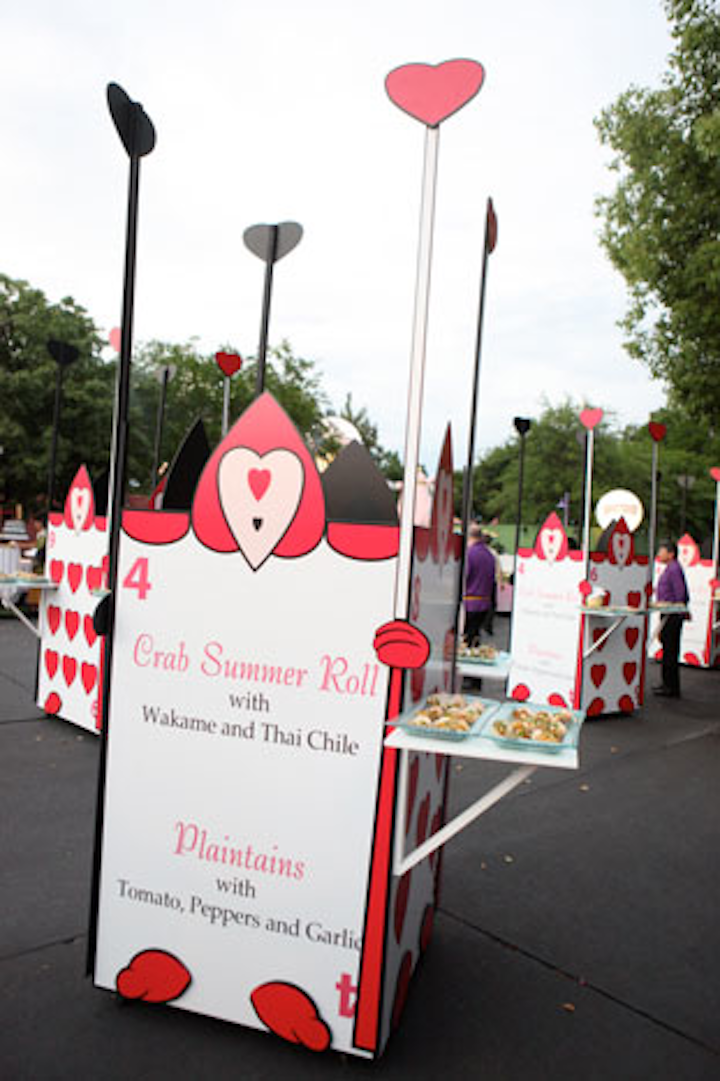 Oversize playing cards resembling the Queen of Hearts' guards from Alice in Wonderland displayed menu descriptions and served as small food stations.