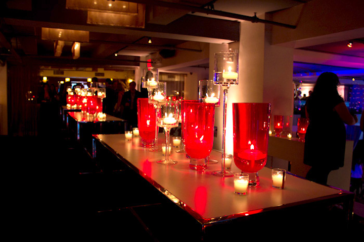 Candles housed inside red hand-blown glass torchieres and stemmed clear glass votives dominated the decor.