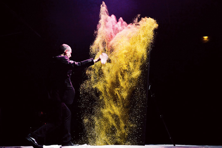 French glitter painter Erik Black specializes in portraits. A typical presentation consists of Black outlining an image in clear glue on dark canvas, then tossing glitter over the piece to reveal it to his audience. Performances include as many as two demos with options like upside-down painting or UV painting in the dark. Black is available for international travel; presentations range from $4,480 to $5,300.