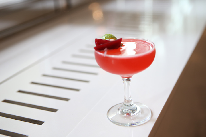 At Filini Bar & Restaurant at Chicago's Radisson Blu Aqua Hotel, the 'Cranberry Spice' cocktail is served during the holiday season. The cocktail blends Aperol and hard cider with house-made ginger simple syrup, Lillet Blanc, and house-made nutmeg syrup. The unexpected garnish contains sweet-and-sour beets and a lime.