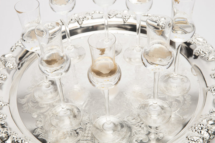 Limelight's 'Gilded Vanilla Cordials' combine vanilla vodka and Goldschläger with edible gold dust. The drinks are served on silver platters and have gold dust on their rims.