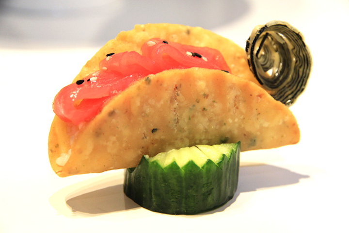 Taco shells made from rice flour and sushi rice, filled with tuna and salmon, and sprinkled with sesame seeds, by Encore Catering in Toronto