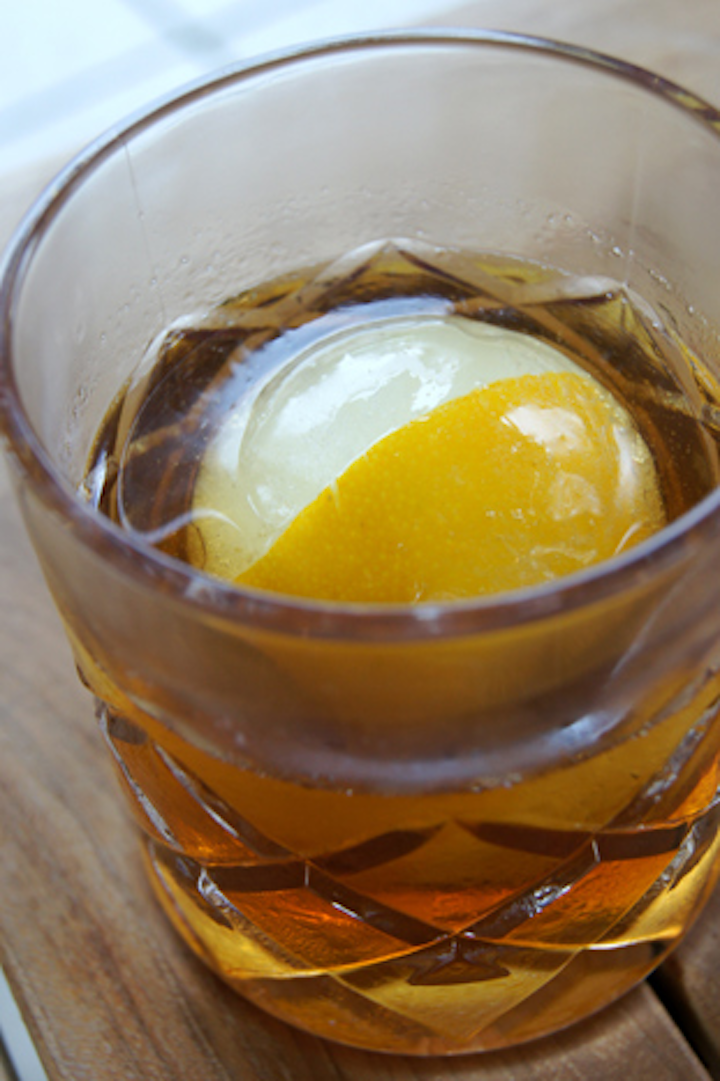 Highball & Harvest, the new restaurant at the Ritz Carlton Orlando, Grande Lakes, serves an inventive cocktail called the Last Wish. The drink—served with an ice sphere holding a frozen orange peel—contains whiskey, spiced cola syrup, Old Havana tobacco bitters, and orange essence.