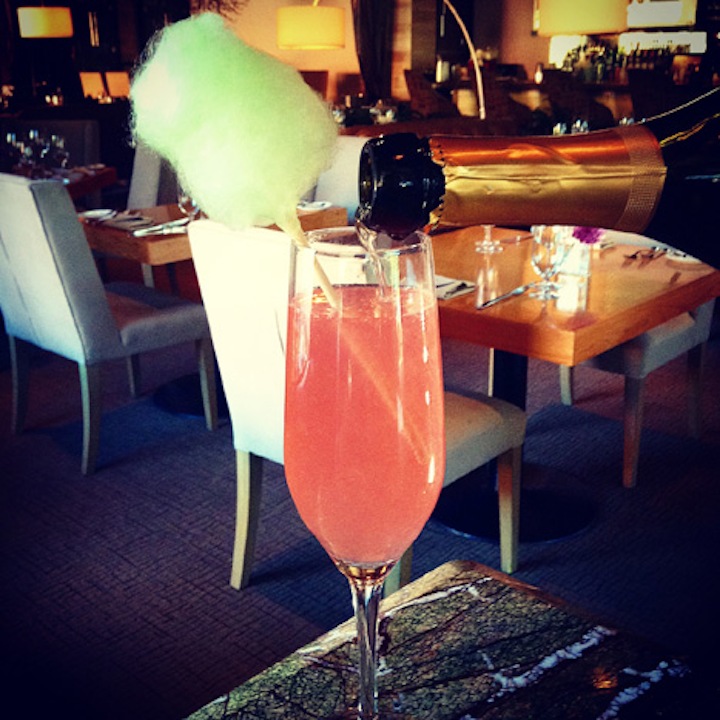 Dallas restaurant Oak has a whimsical drink called the State Fair. The cocktail, which combines pomegranate and lemon liqueurs with champagne, is topped with a stick of lime cotton candy that's made at the bar.
