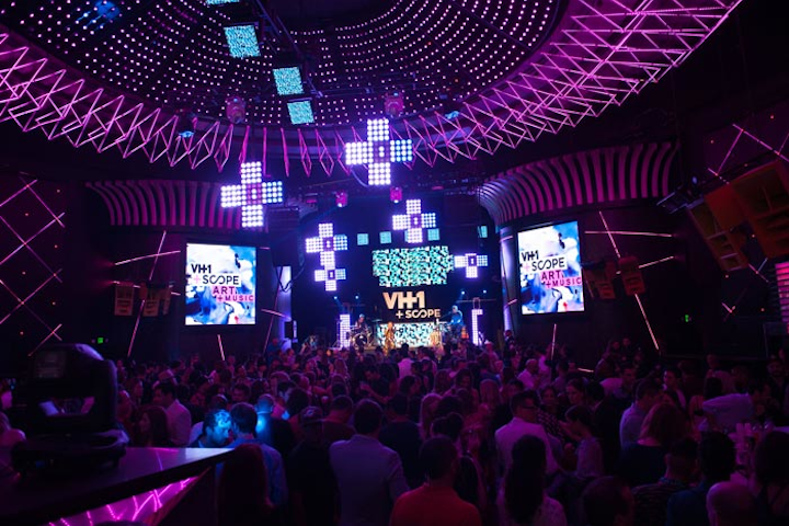 The Official VH1 & Scope Party, now in its third year, incorporated the event's plus-shaped logo into the stage design and lighting. VH1 and parent company Viacom produced the event, which was held at Mansion nightclub on December 5. The plus signs were made up of nexus light squares and would flash, show patterns, or change color to suit the music.