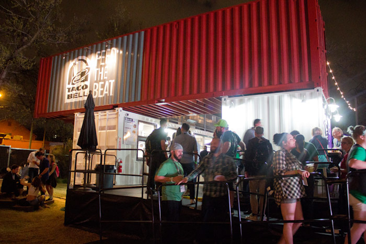 Hype Hotel switched venues to a bigger space at the Fair Market for its music showcase, which allowed sponsor Taco Bell to create a storage container restaurant in the outdoor space, complete with a taco storefront and patio.