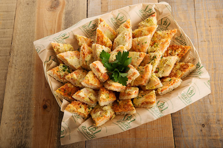 Artichoke and four-cheese focaccia flatbread with marinara sauce, by Bi-Rite Catering in San Francisco