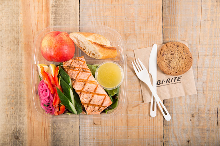 Roasted salmon with citrus vinaigrette served on a bed of fresh greens, served with a baguette roll, seasonal fruit, or a chocolate chip cookie, by Bi-Rite Catering in San Francisco