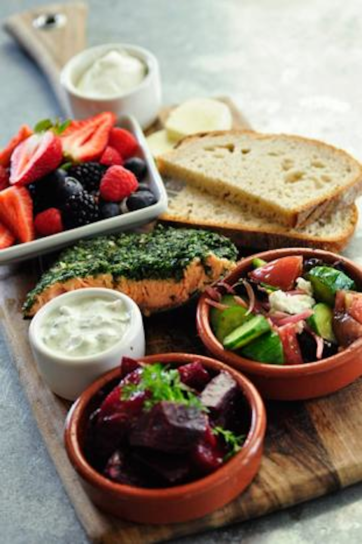 Slow-roasted salmon with cucumber-dill yogurt sauce, served with a mixed grain salad, broccoli with arbol chili, and berries with crème fraîche, by the Larder in Los Angeles