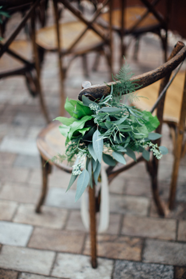 “Having each seat accented with a gorgeous, lush green bundle brings the outside in, even in the coldest of times,” says designer Christina Janda.