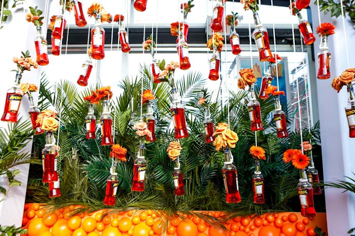 Aperol Spritz hosted its Summer Solstice party on June 22 at the Sabbia rooftop at Eataly in New York. Designed by creative and content production studio Swell, the party featured an installation of hanging bottles of the Italian aperitif that served as vases for orange flowers, including marigolds.